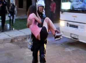 Polis eylemciyi kucağında taşıdı